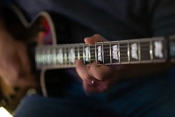 Close-up of a guitarist playing an electric guitar