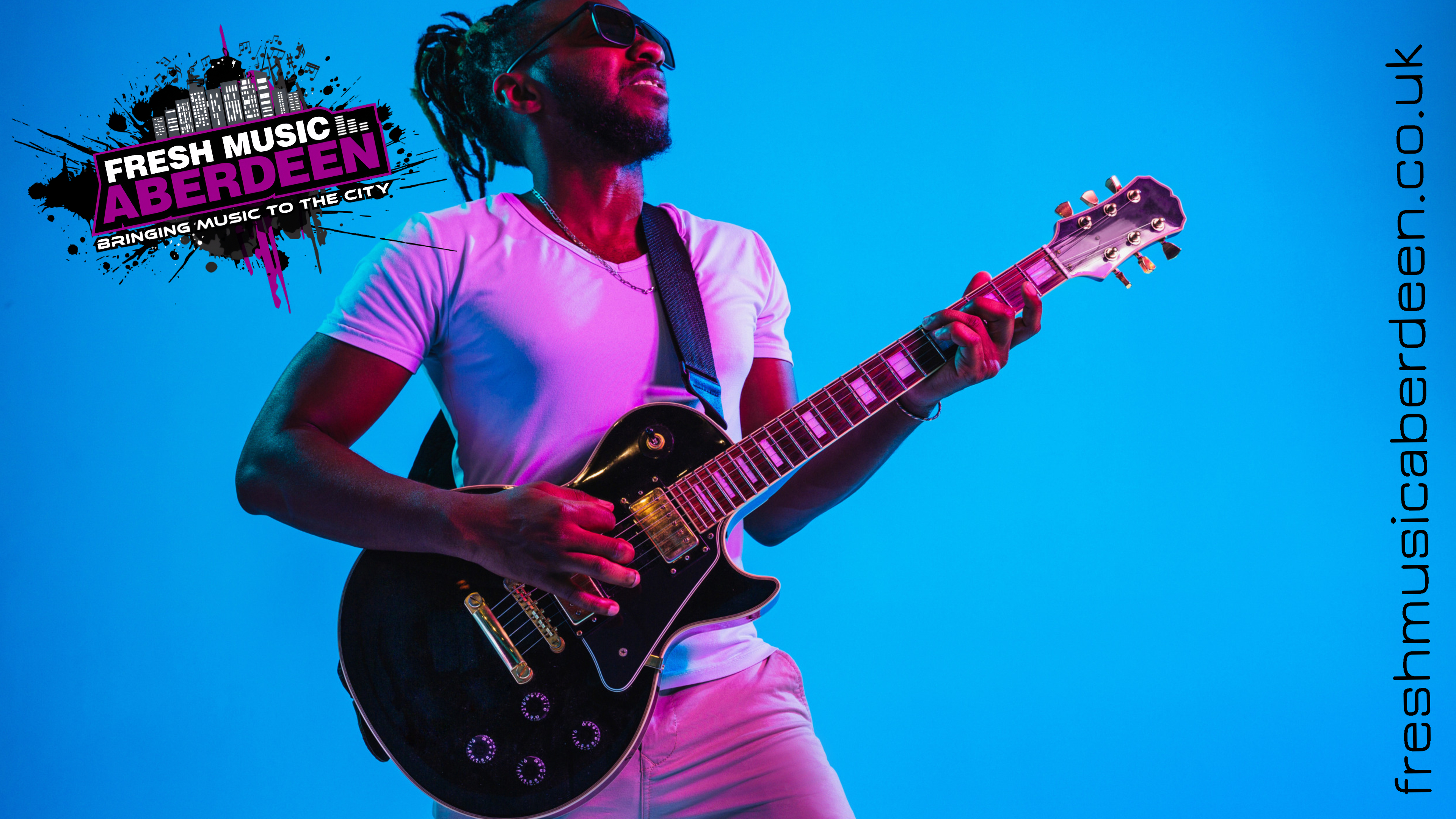 Guitarist playing an electric guitar against a blue backdrop beside the Fresh Music Aberdeen logo